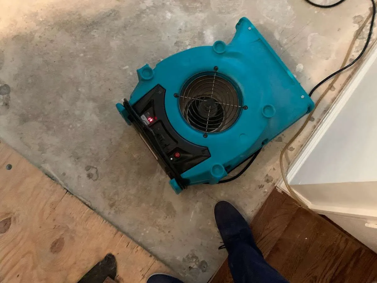 Air mover drying subfloor during Leak Detection & Repair in Chippewa Falls